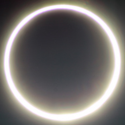 The Moon appears as a smooth black disk that blocks the center of the Sun. As a result, the Sun appears to be a very bright ring of fire, glowing around the Moon’s circular edge.