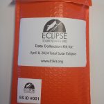 Orange bubble envelop with the Eclipse Soundscapes logo on it and text that describes it as a Data Collector kit for the April 8, 2024 total solar eclipse.