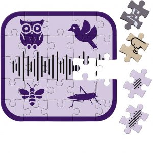 A partially completed jigsaw puzzle featuring a design with an owl, a bird, a bee, a cricket, and a central soundwave. Most of the puzzle is assembled, but two pieces are missing. To the side, two loose pieces show parts of the same design and appear to fit exactly into the open spaces, making the puzzle look nearly complete.