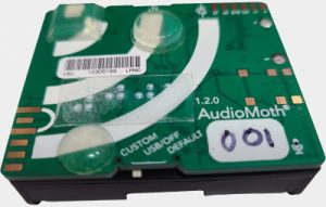 Square circuit board attached to 3 batteries about 3 inches by 3 inches in size.